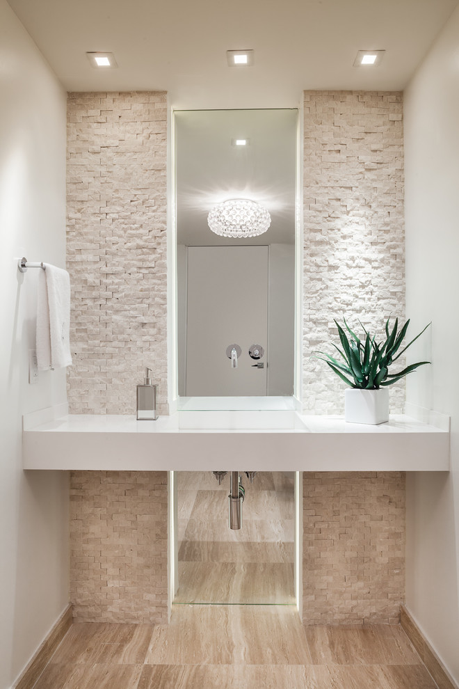 This is an example of a small contemporary powder room in Miami with an integrated sink, white walls, light hardwood floors, open cabinets, white cabinets, a two-piece toilet, beige tile, stone tile, quartzite benchtops, beige floor and white benchtops.