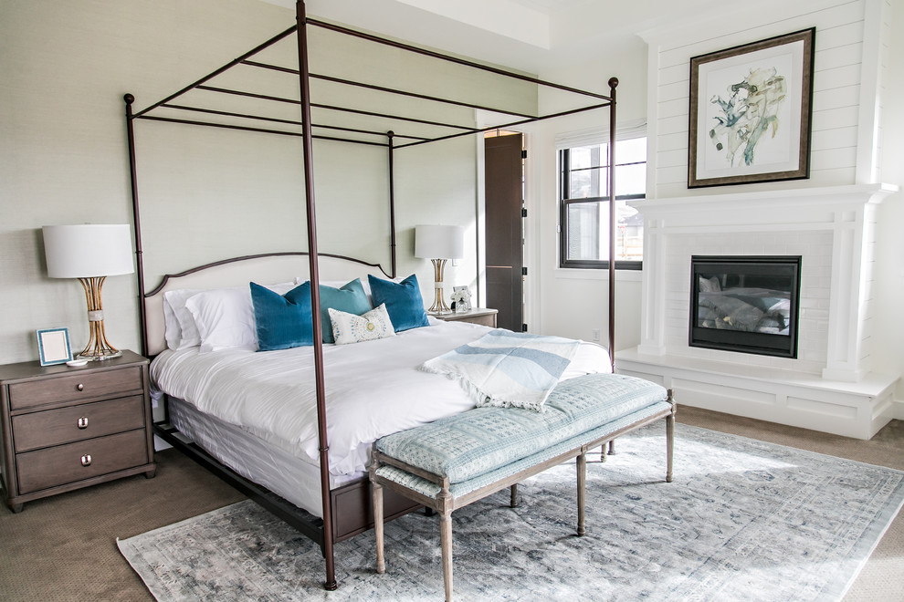 Inspiration for a large country guest bedroom in Salt Lake City with white walls, carpet, a standard fireplace, a tile fireplace surround and brown floor.