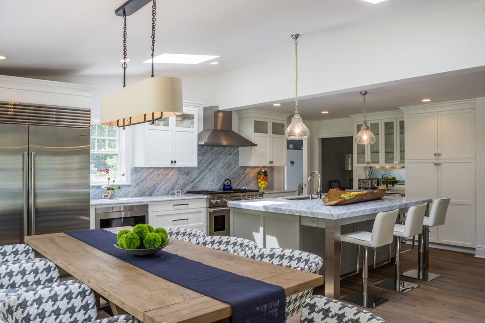 Open concept kitchen - mid-sized transitional medium tone wood floor and brown floor open concept kitchen idea in New York with an undermount sink, shaker cabinets, white cabinets, marble countertops, blue backsplash, marble backsplash, stainless steel appliances and an island