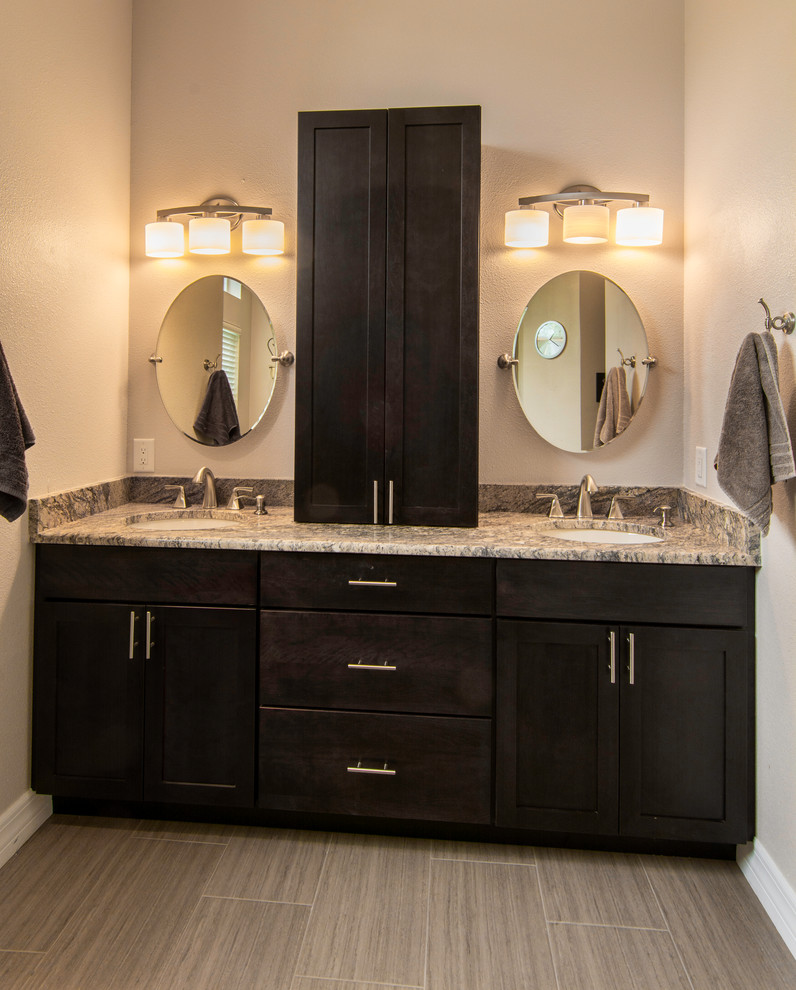 Inspiration for a mid-sized transitional master bathroom in Tampa with an undermount sink, flat-panel cabinets, dark wood cabinets, granite benchtops, an open shower, a one-piece toilet, gray tile, porcelain tile, beige walls and porcelain floors.