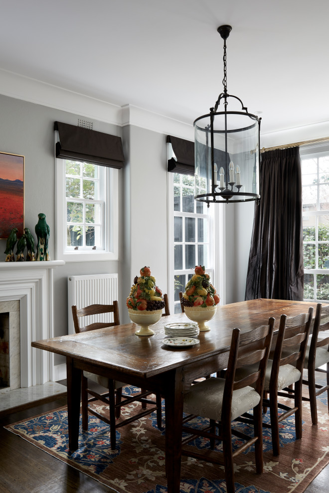 Photo of a traditional dining room in Melbourne with grey walls, dark hardwood floors and brown floor.
