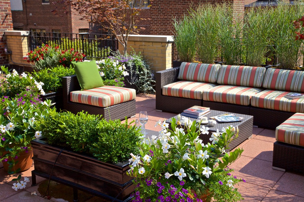 This is an example of a large contemporary rooftop deck in New York with a container garden.