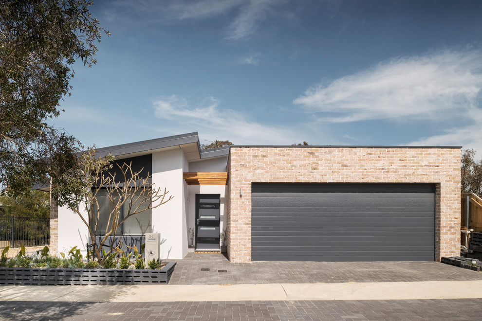 Design ideas for a mid-sized contemporary one-storey brick multi-coloured house exterior in Perth with a flat roof and a metal roof.