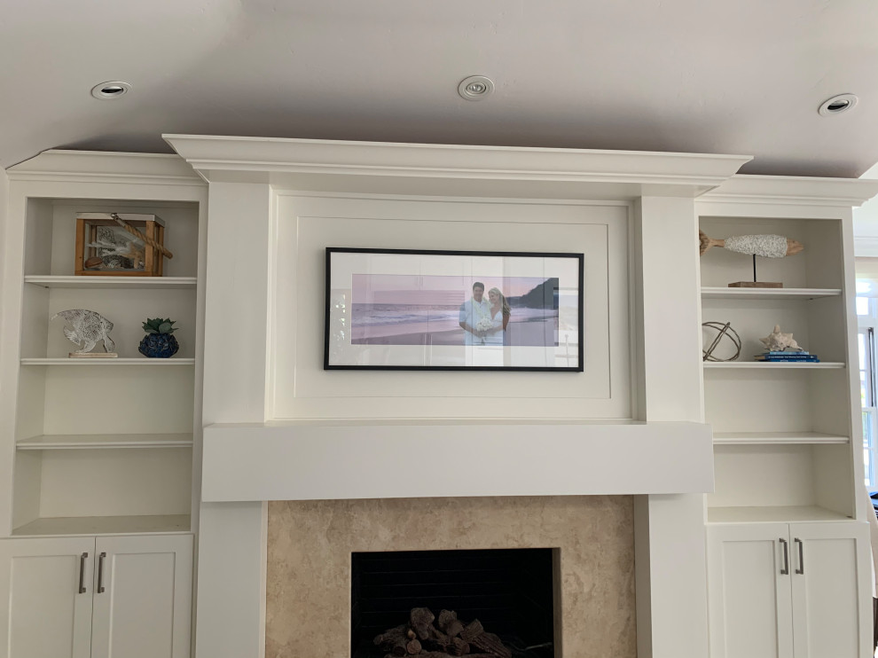 Inspiration for a large transitional travertine floor and beige floor kitchen remodel in Orange County with a single-bowl sink, shaker cabinets, white cabinets, quartzite countertops, white backsplash, ceramic backsplash, stainless steel appliances, an island and black countertops