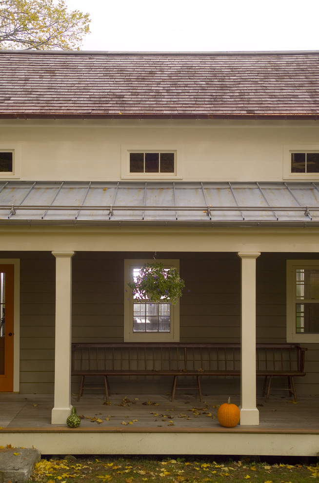 Country porch photo in New York with decking and a roof extension