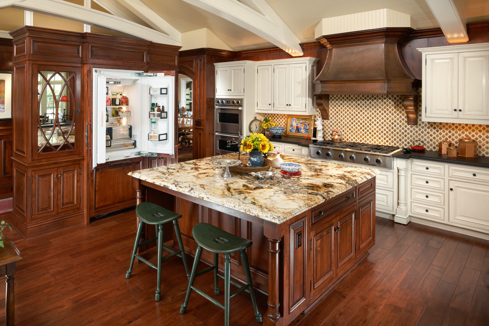 Photo of a traditional kitchen in Phoenix with raised-panel cabinets, panelled appliances and granite benchtops.