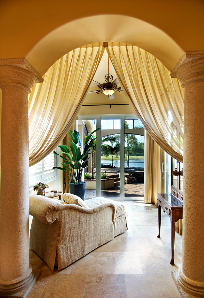 This is an example of a large mediterranean sunroom in Miami.