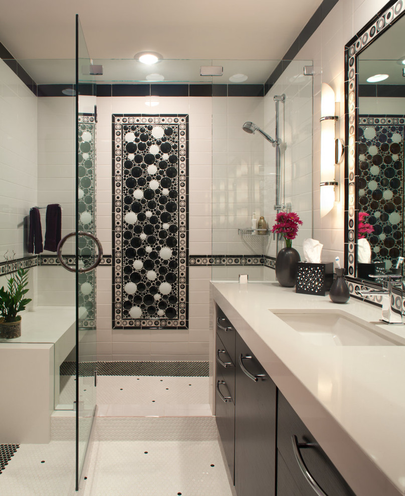 This is an example of a mid-sized contemporary 3/4 bathroom in San Diego with an undermount sink, flat-panel cabinets, black cabinets, an alcove shower, black and white tile, ceramic tile, white walls, ceramic floors, solid surface benchtops, yellow floor, a hinged shower door and white benchtops.