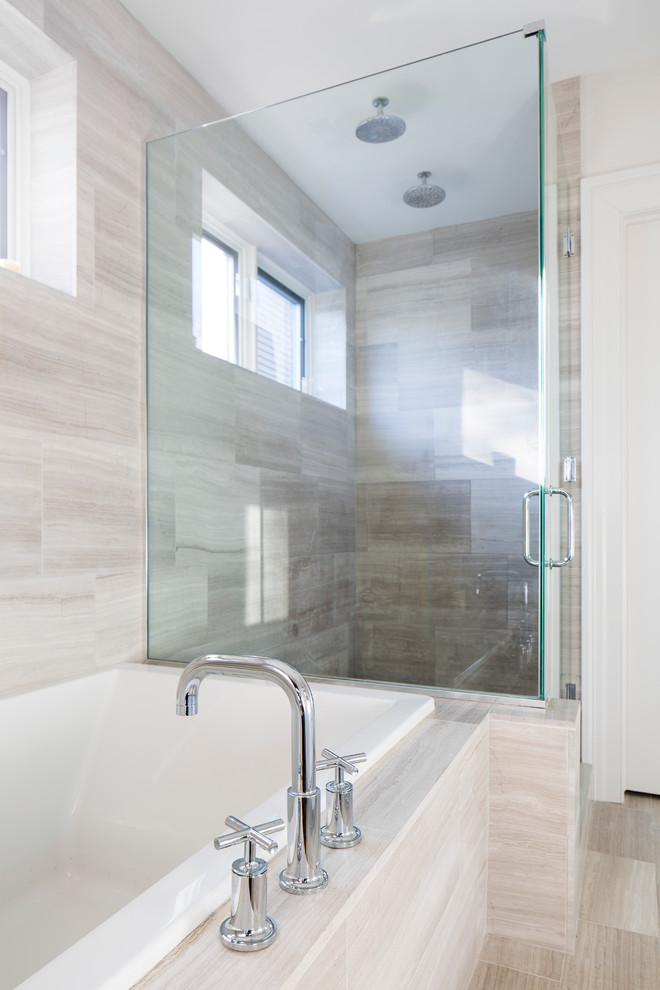 This is an example of a large contemporary master bathroom in Chicago with a drop-in tub, a corner shower, beige tile, porcelain tile, beige walls, porcelain floors, an undermount sink, recessed-panel cabinets, white cabinets, a two-piece toilet, engineered quartz benchtops, grey floor and a hinged shower door.