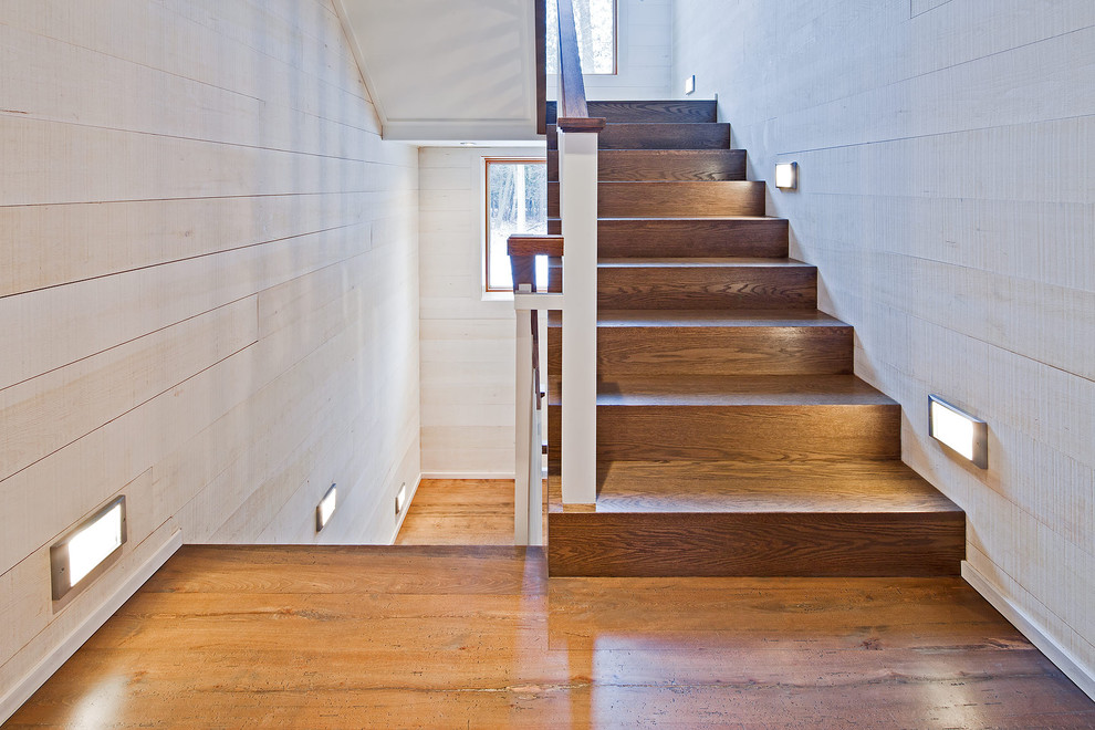 Design ideas for a country wood u-shaped staircase in Toronto with wood risers.
