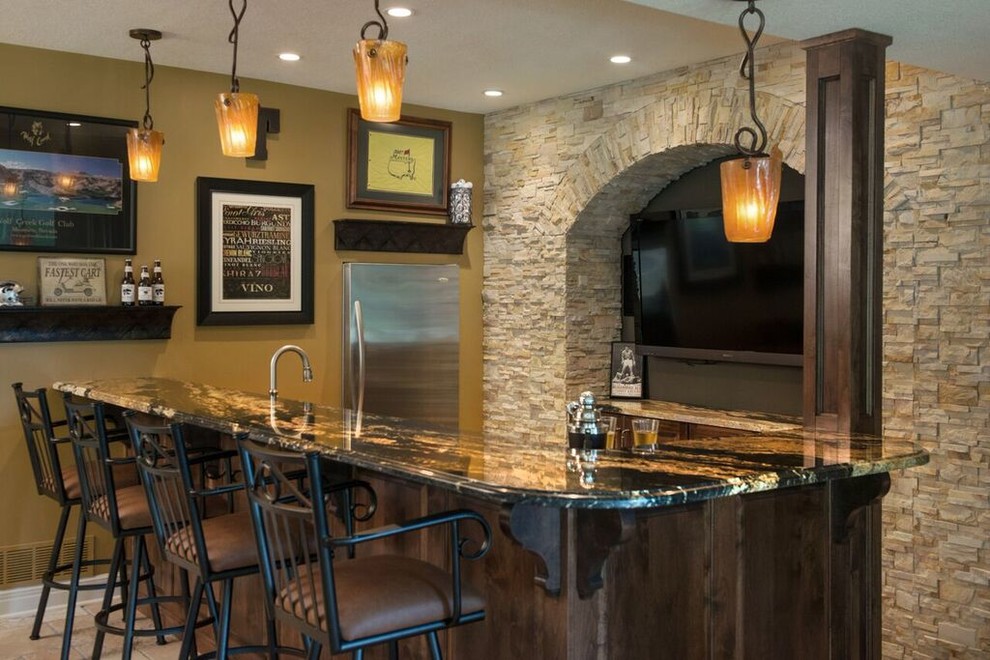 Photo of a mid-sized country u-shaped seated home bar in Kansas City with distressed cabinets, granite benchtops, travertine floors, beige floor and an undermount sink.