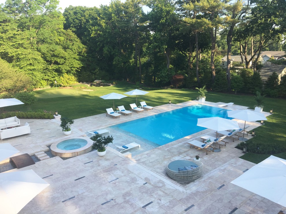 Large backyard stone and rectangular lap hot tub photo in New York