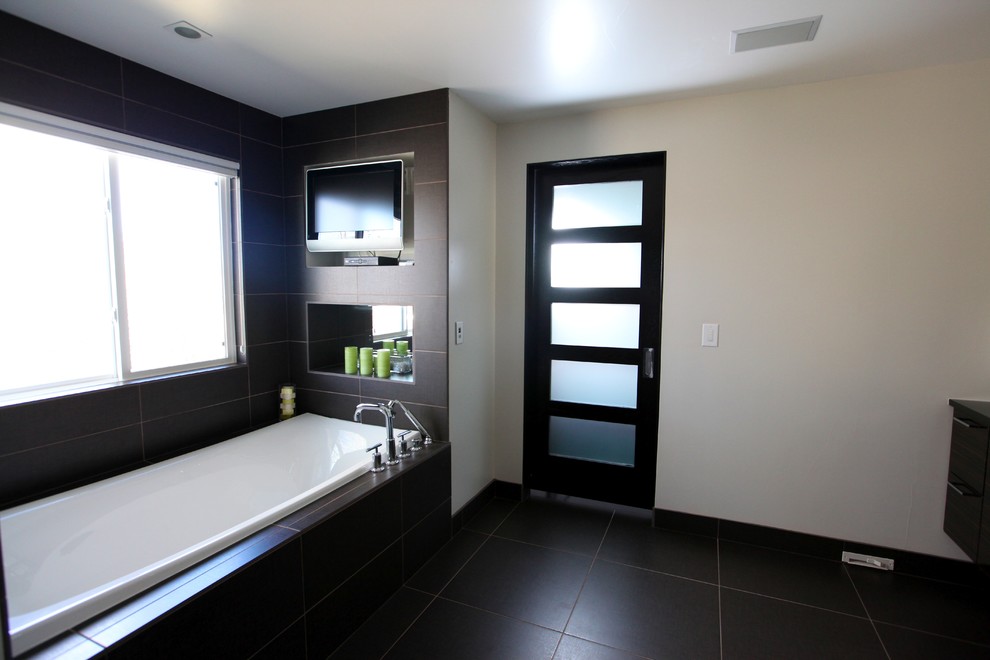 Photo of a contemporary master bathroom in Denver with a drop-in tub, brown tile, porcelain tile, white walls and porcelain floors.