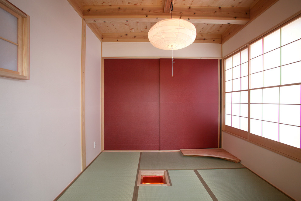 This is an example of an asian family room in Other with white walls, tatami floors and green floor.