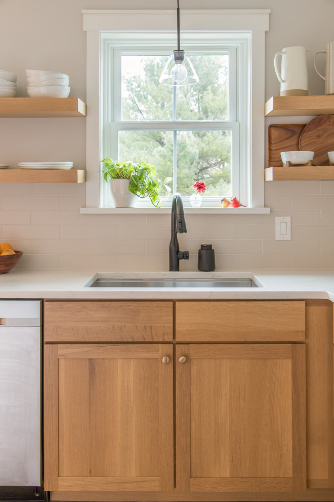 Inspiration for a mid-sized transitional u-shaped light wood floor and brown floor eat-in kitchen remodel with an undermount sink, shaker cabinets, white cabinets, white backsplash, subway tile backsplash, no island and white countertops