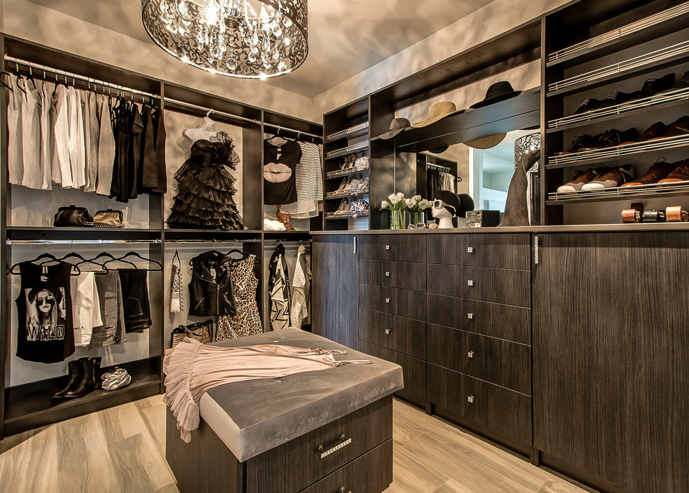 Photo of a large contemporary gender-neutral dressing room in Vancouver with flat-panel cabinets and dark wood cabinets.