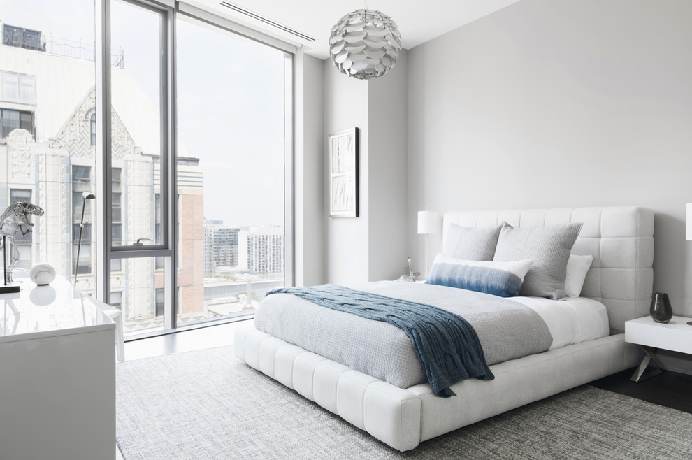 Contemporary bedroom in Chicago with grey walls.