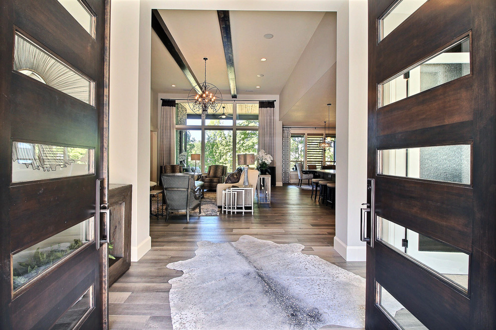 This is an example of an expansive transitional foyer in Portland with beige walls, light hardwood floors, a double front door, a dark wood front door and brown floor.
