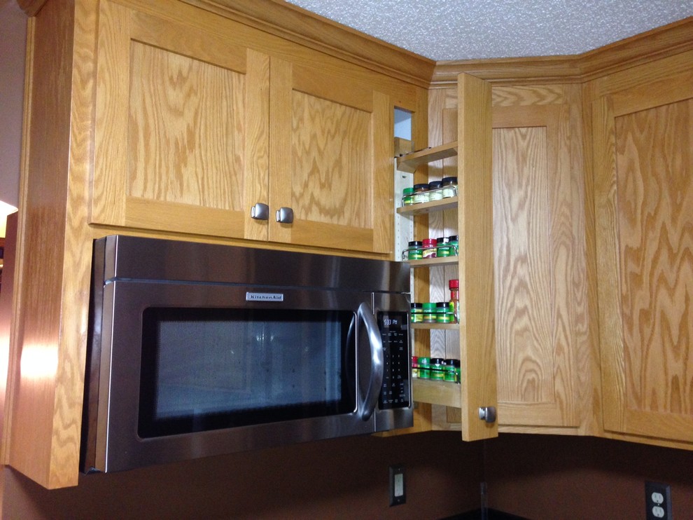 Kitchen - mid-sized kitchen idea in Minneapolis with light wood cabinets, stainless steel appliances and no island