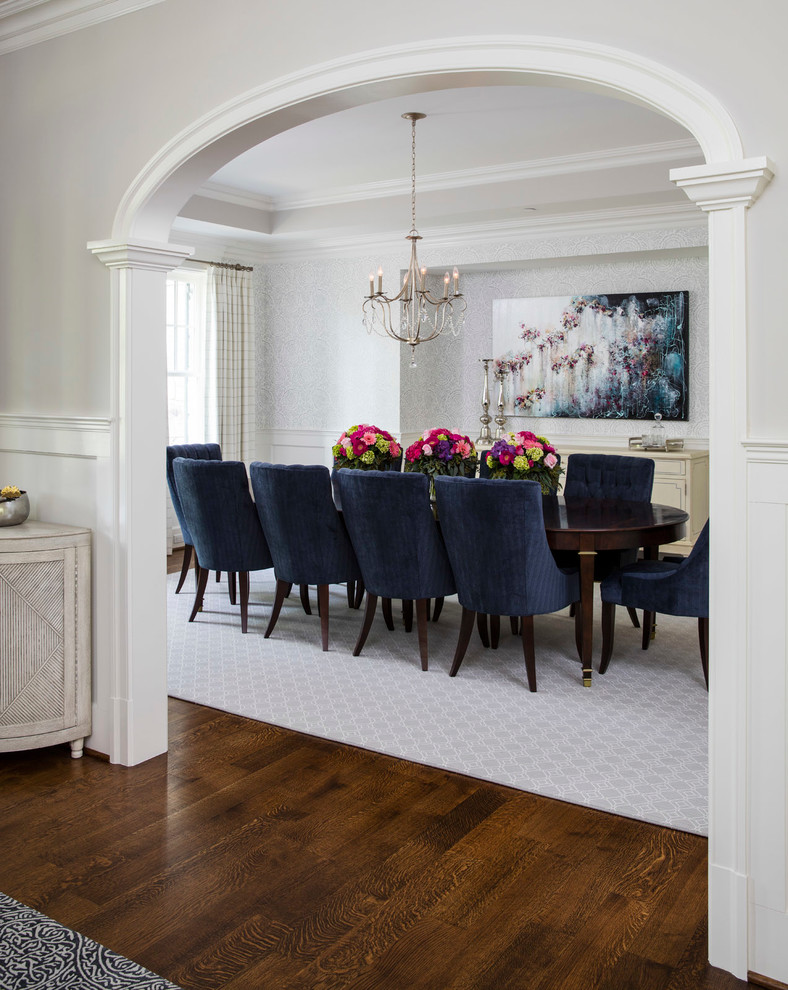 This is an example of a traditional dining room in DC Metro with grey walls and dark hardwood floors.