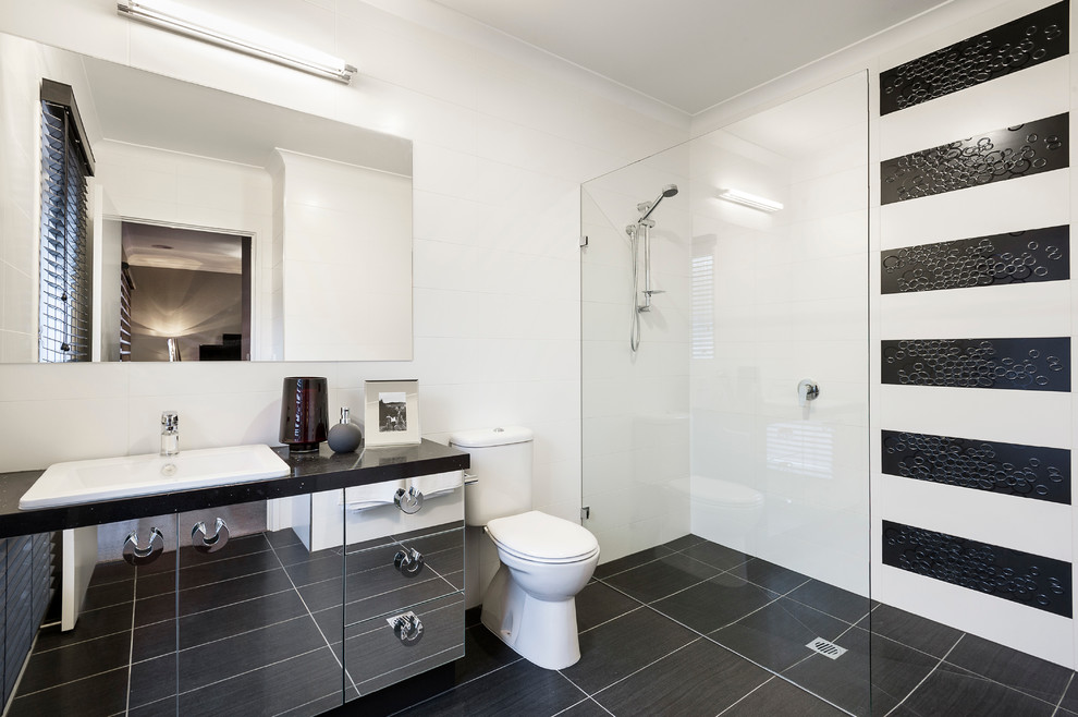 Small modern master bathroom in Sydney with a drop-in sink, glass-front cabinets, engineered quartz benchtops, a curbless shower, a two-piece toilet, white tile, ceramic tile, white walls and ceramic floors.