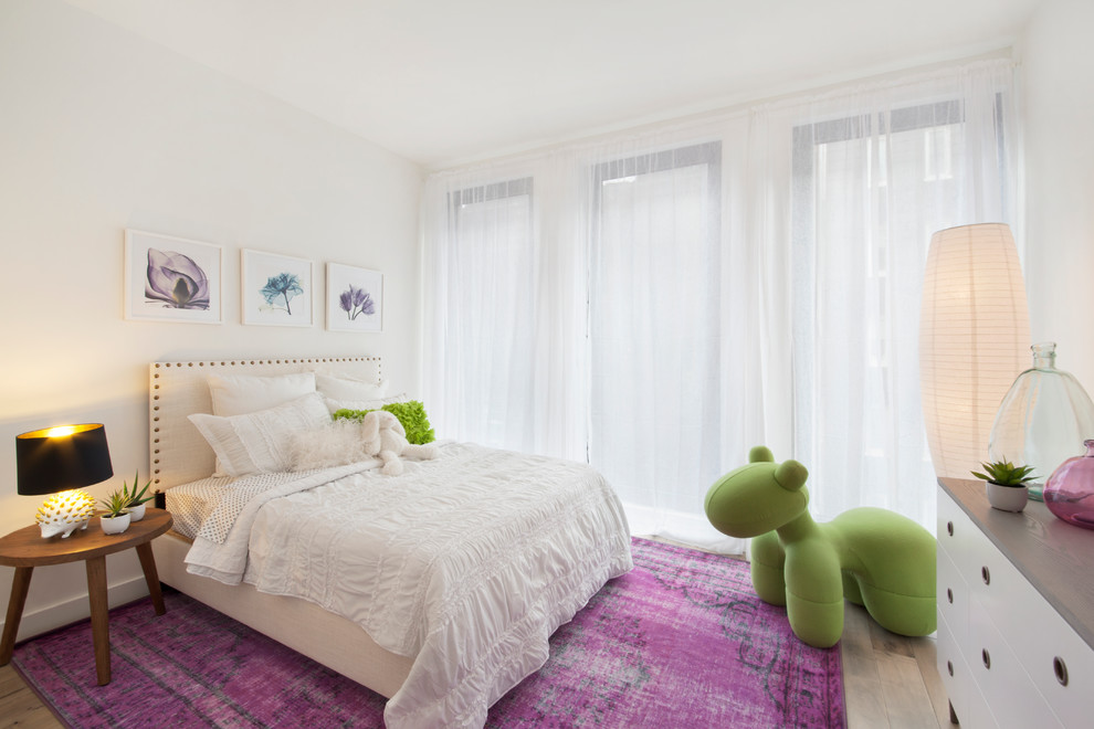 Mid-sized contemporary kids' bedroom in New York with white walls and light hardwood floors for girls.