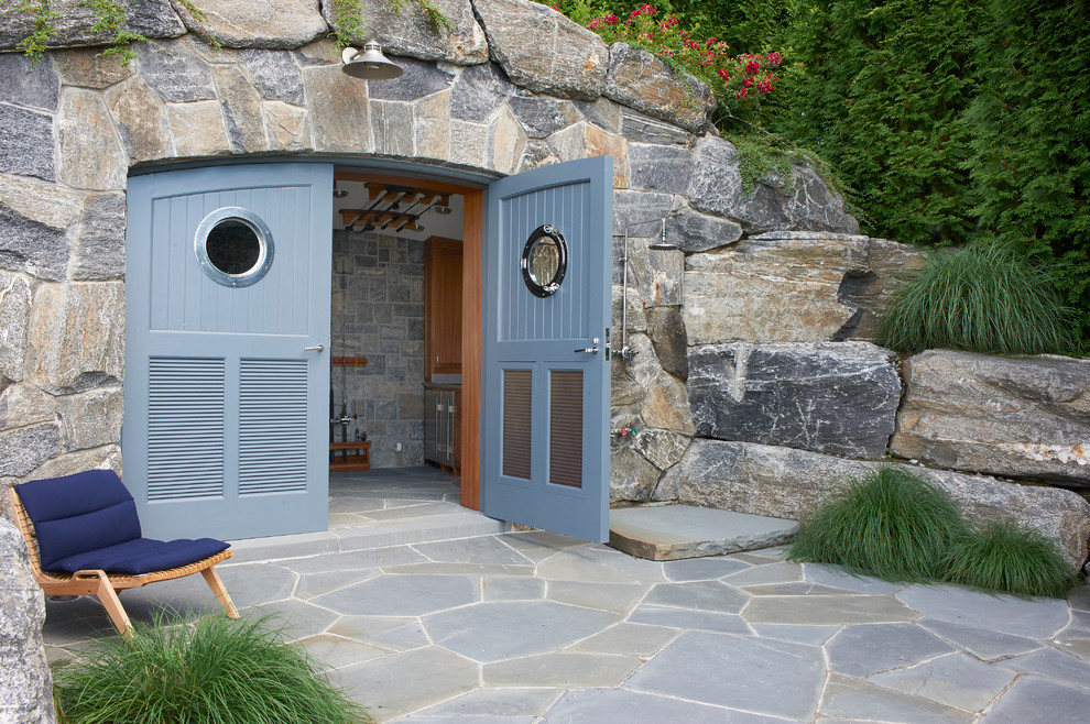Small traditional backyard patio in New York with an outdoor shower and natural stone pavers.