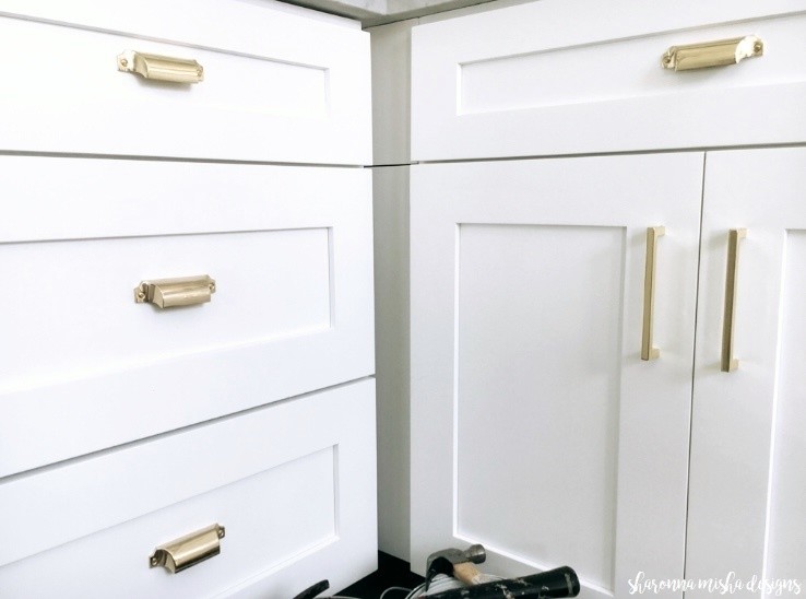 Inspiration for a small transitional painted wood floor and white floor enclosed kitchen remodel with an undermount sink, shaker cabinets, white cabinets, marble countertops, white backsplash, marble backsplash, stainless steel appliances, no island and white countertops
