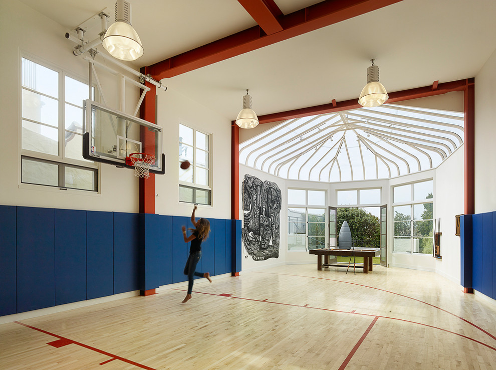 Inspiration for a large mediterranean indoor sport court in San Francisco with white walls, light hardwood floors and beige floor.