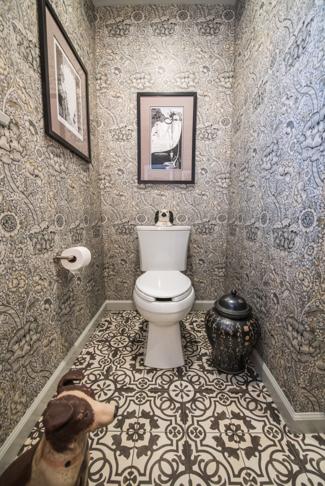 This is an example of a small eclectic powder room in Bridgeport with white cabinets, a two-piece toilet, white tile, ceramic tile, porcelain floors, an undermount sink, soapstone benchtops, black benchtops, a built-in vanity and wallpaper.