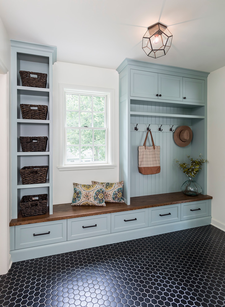 Mid-sized traditional mudroom in Minneapolis with white walls, porcelain floors and black floor.