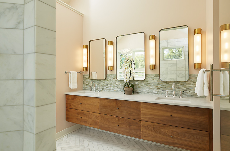 Large midcentury master bathroom in Grand Rapids with flat-panel cabinets, brown cabinets, a freestanding tub, an alcove shower, a two-piece toilet, multi-coloured tile, matchstick tile, pink walls, marble floors, an undermount sink, engineered quartz benchtops, white floor, a hinged shower door and white benchtops.