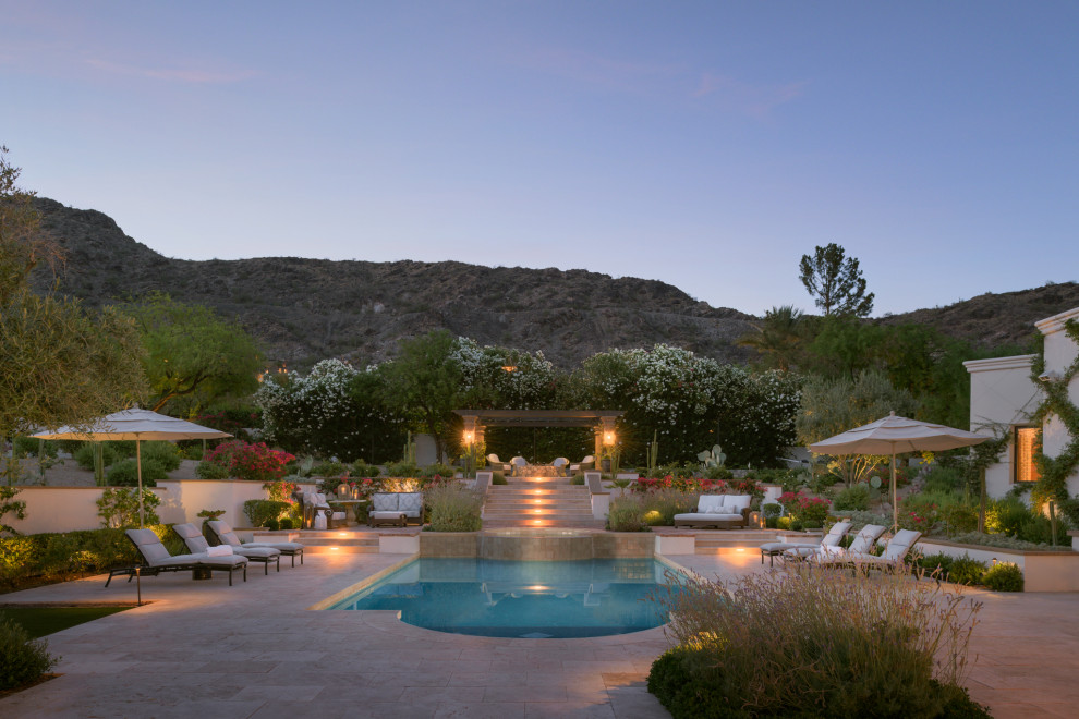 Photo of an expansive transitional backyard custom-shaped natural pool in Phoenix with with a pool and brick pavers.