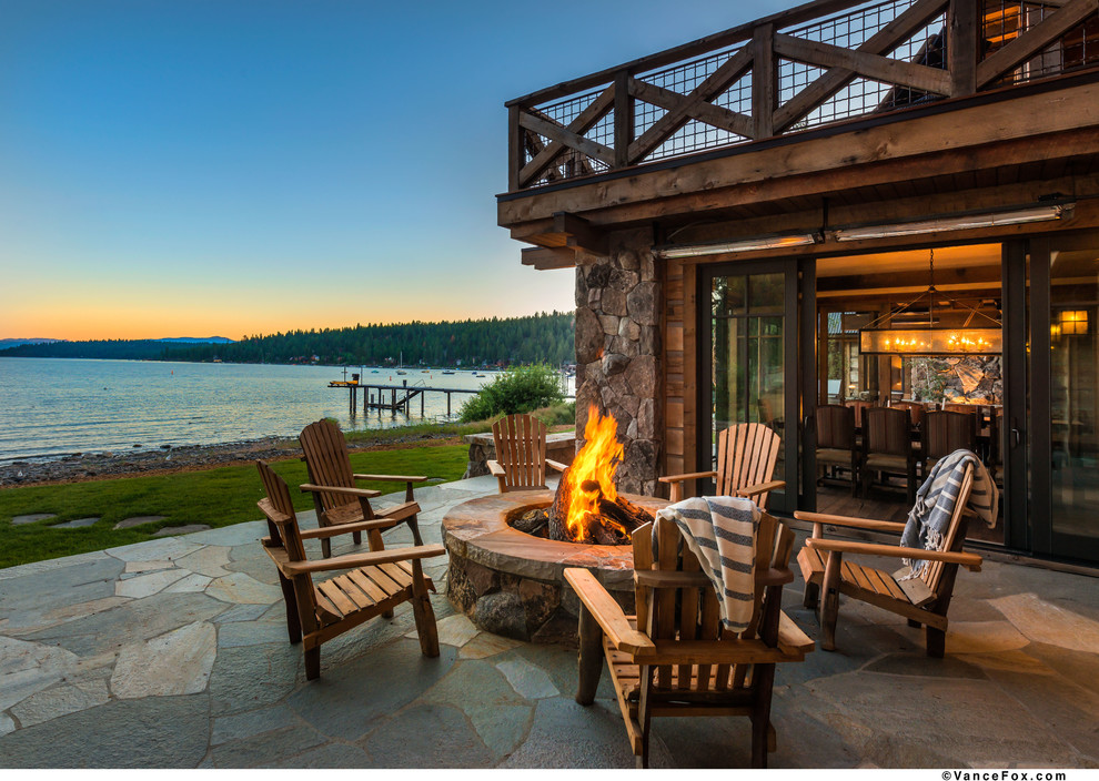 This is an example of a country backyard patio in Sacramento with a fire feature.