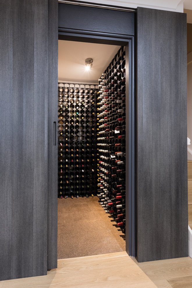 Design ideas for a contemporary wine cellar in Sydney with light hardwood floors and beige floor.