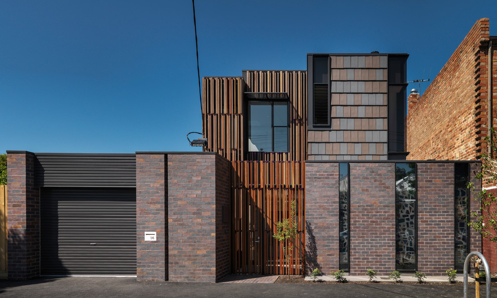Photo of a small industrial two-storey brown exterior in Melbourne with mixed siding and a flat roof.