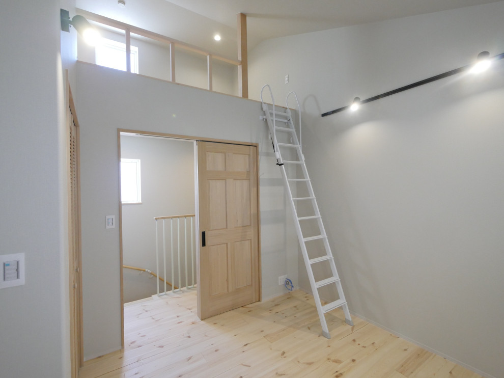 Danish light wood floor, beige floor, wallpaper ceiling and wallpaper playroom photo in Fukuoka with gray walls