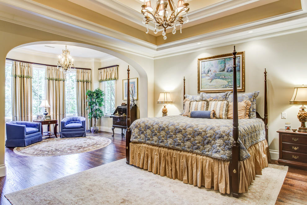 Design ideas for an expansive traditional master bedroom in Other with beige walls and medium hardwood floors.