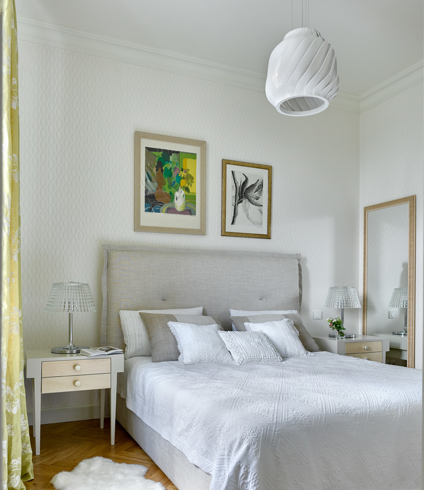 Photo of a contemporary master bedroom in Moscow with white walls and medium hardwood floors.
