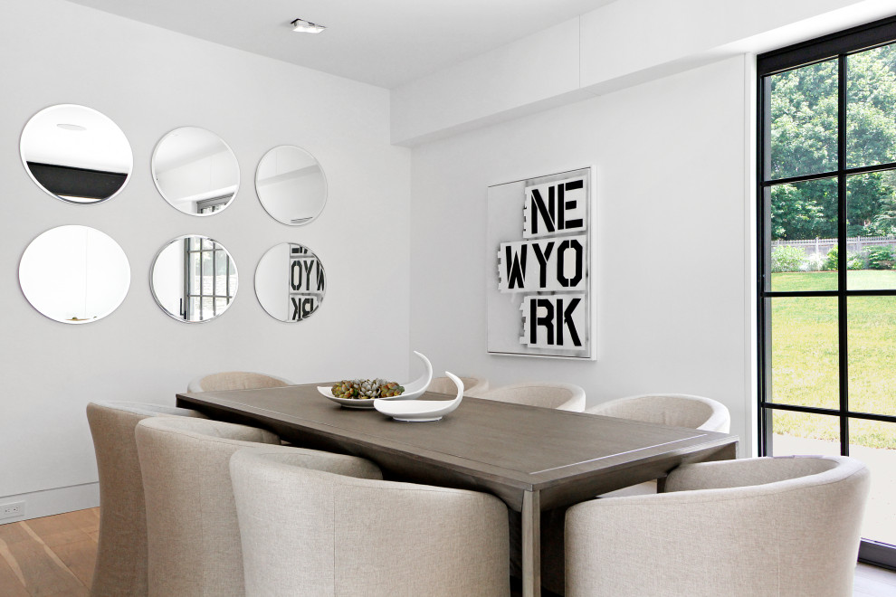 Mid-sized contemporary separate dining room in New York with white walls, light hardwood floors and beige floor.