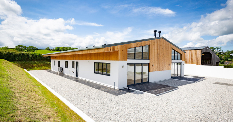 Inspiration for a large farmhouse one-story wood and board and batten exterior home remodel in Devon with a metal roof and a gray roof