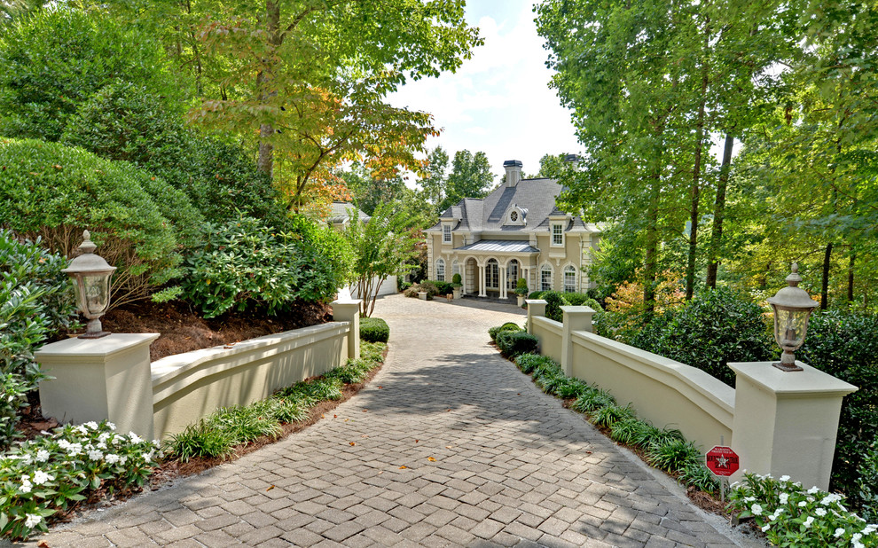 This is an example of a traditional front yard driveway in Atlanta with concrete pavers.
