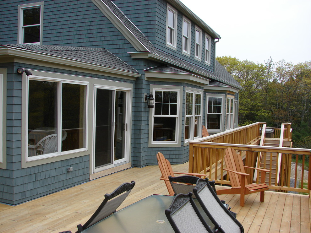 This is an example of a large traditional three-storey blue exterior in Portland Maine with wood siding and a gable roof.