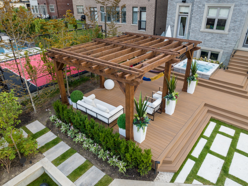 Ejemplo de terraza planta baja clásica renovada de tamaño medio en patio trasero con jardín de macetas y pérgola