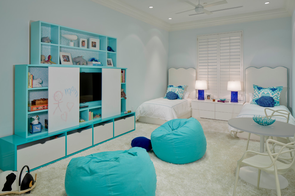 This is an example of a large transitional kids' bedroom for kids 4-10 years old and girls in Miami with blue walls and carpet.