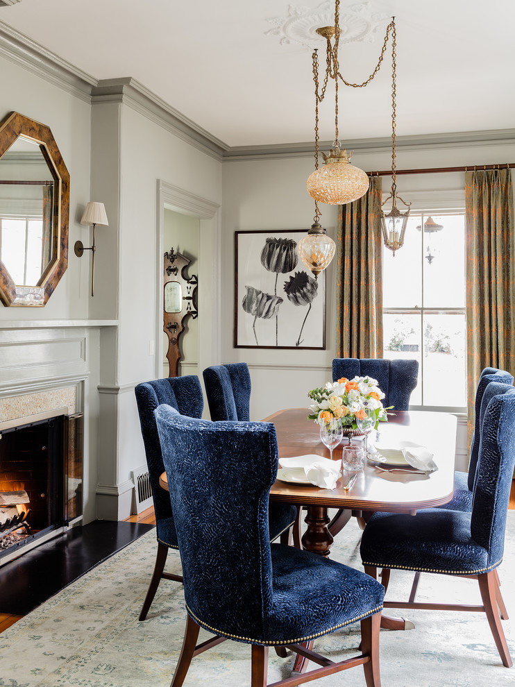 Photo of a traditional dining room in Boston with grey walls and a standard fireplace.