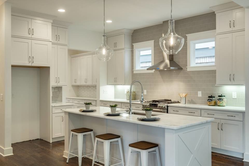 Design ideas for a large contemporary galley eat-in kitchen in Nashville with a single-bowl sink, shaker cabinets, white cabinets, quartzite benchtops, grey splashback, subway tile splashback, stainless steel appliances, dark hardwood floors and with island.