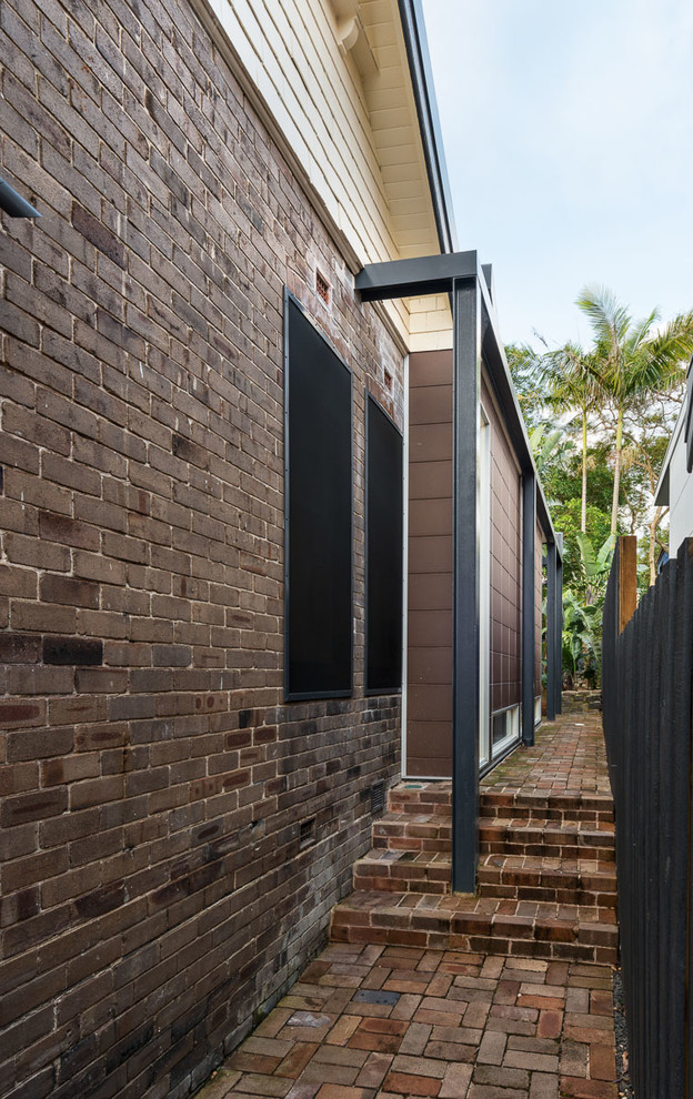 Large contemporary two-storey brown house exterior in Sydney with mixed siding and a flat roof.
