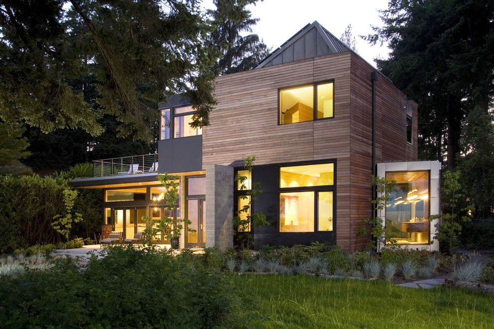 Design ideas for a mid-sized contemporary two-storey beige house exterior in Seattle with wood siding.