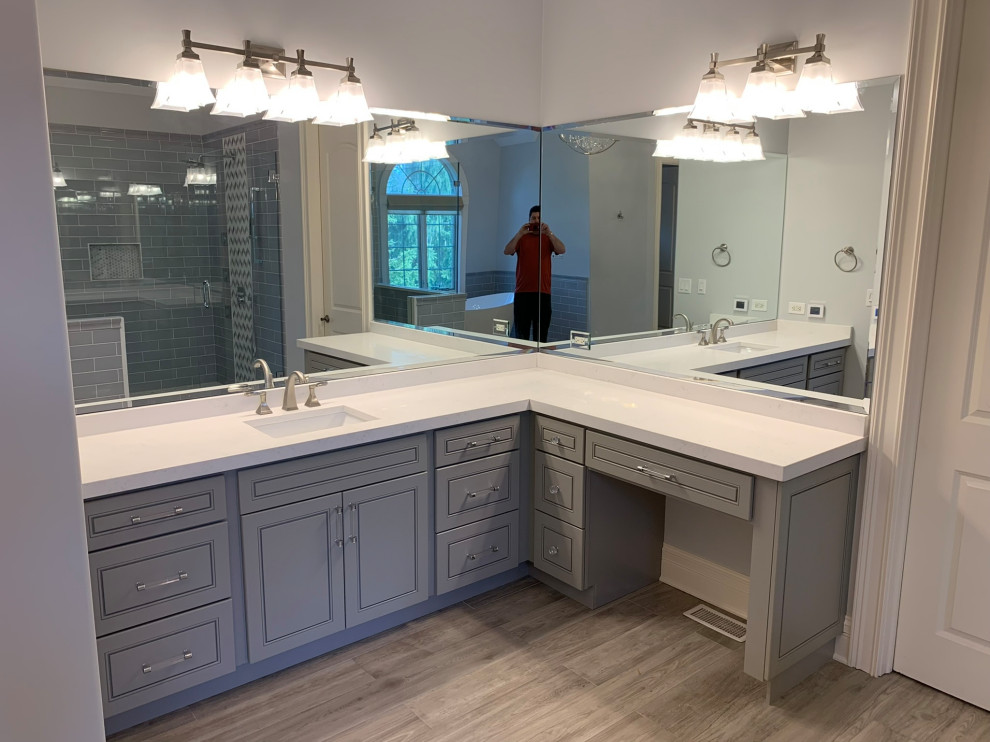 Inspiration for a large transitional master bathroom in Chicago with recessed-panel cabinets, grey cabinets, a corner shower, engineered quartz benchtops, a hinged shower door, a double vanity and a built-in vanity.